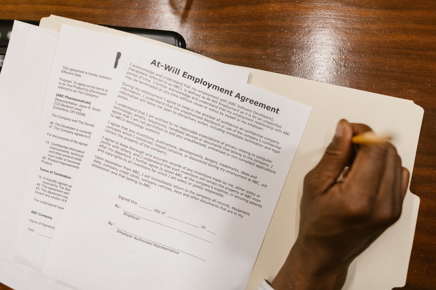 Trabalhador assinando um contrato de trabalho com cláusula de confidencialidade