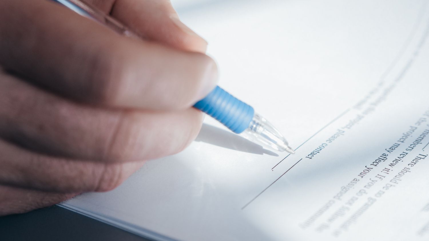 Pessoa assinando acordo ou documento com caneta