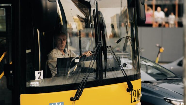 Motorista profissional de ônibus dirigindo pelas ruas da cidade